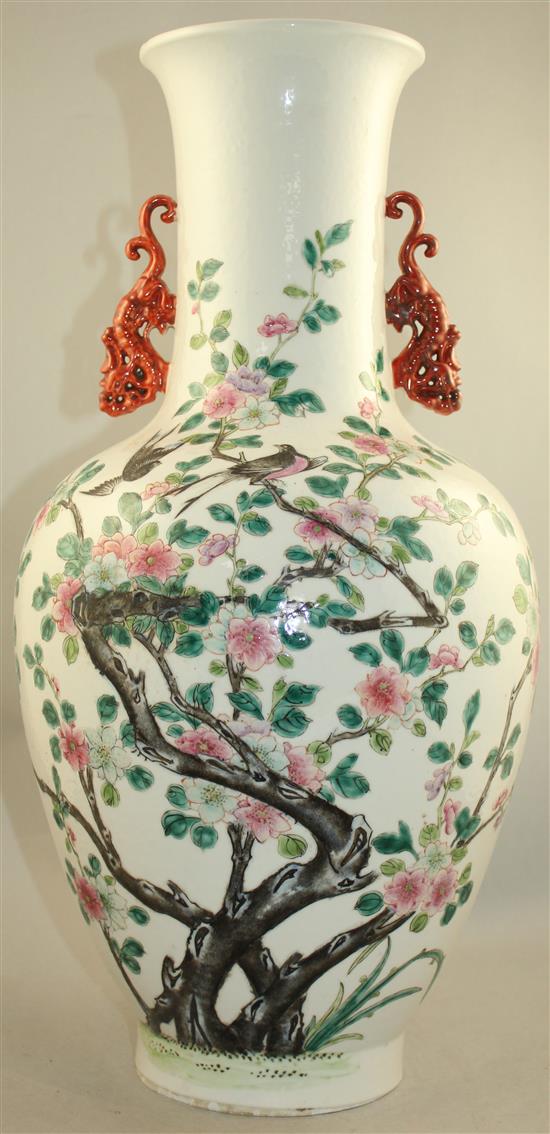 A large Chinese famille rose twin handled bottle vase, Qianlong seal mark, late 19th century, 54cm., foot ground off in manufacture